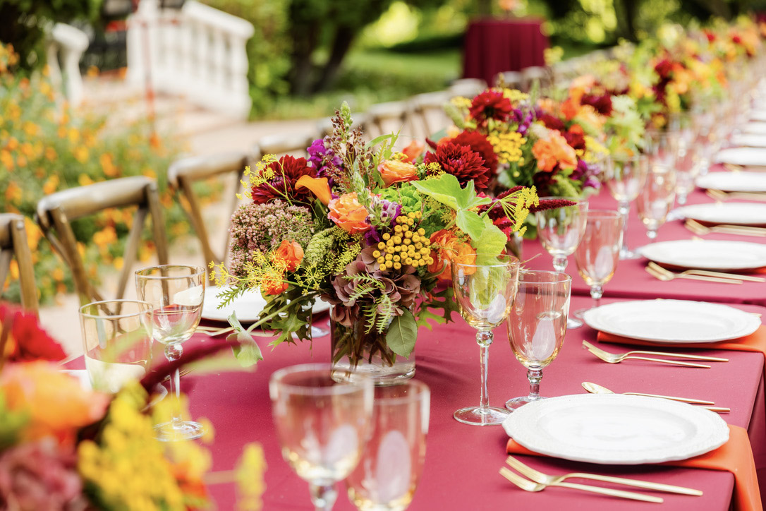 Floral centerpiece on a burgundy dinner table